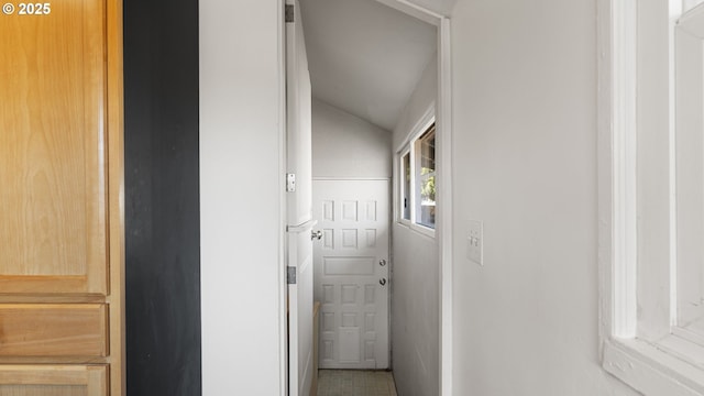 corridor featuring lofted ceiling