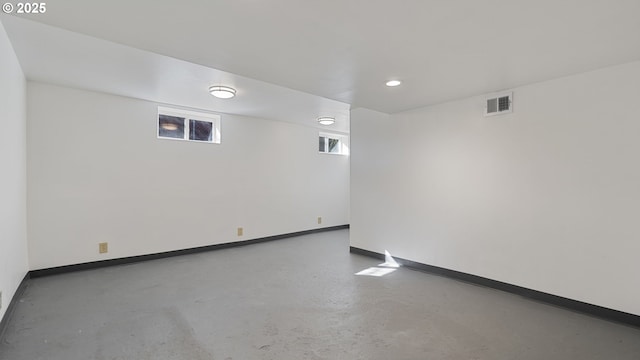 unfurnished room with concrete flooring, recessed lighting, visible vents, and baseboards