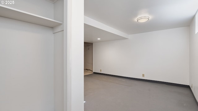 spare room with concrete floors and baseboards