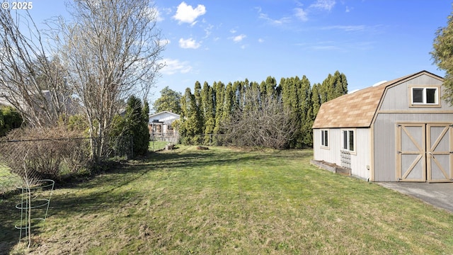 view of yard with an outbuilding, fence, and a storage shed