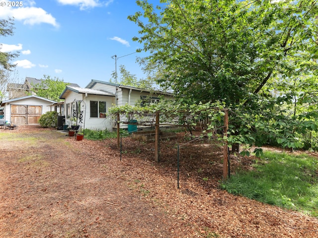 back of house with fence