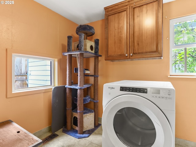 laundry area with washer / clothes dryer, light tile patterned floors, and cabinet space