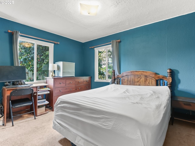 carpeted bedroom with a textured ceiling