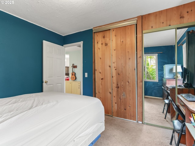 carpeted bedroom featuring a closet and a textured ceiling