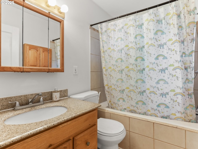 bathroom featuring toilet, shower / bath combination with curtain, and vanity