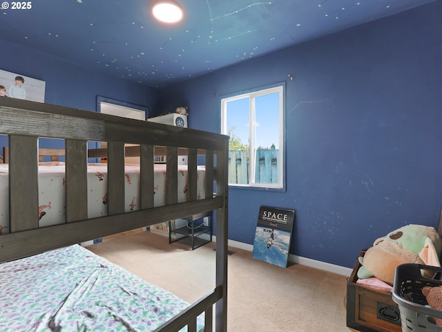 bedroom with baseboards and carpet