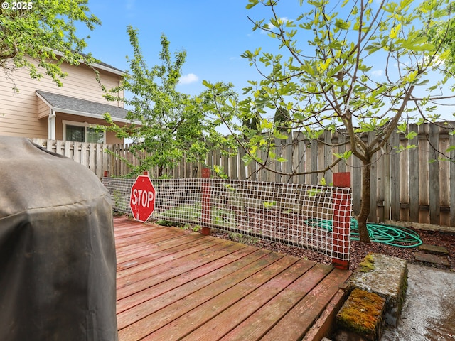 deck with fence and a grill
