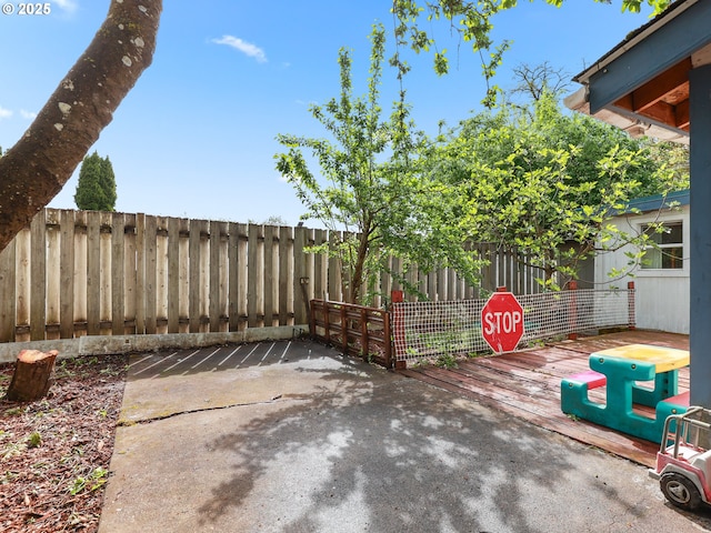 view of patio with fence and a wooden deck