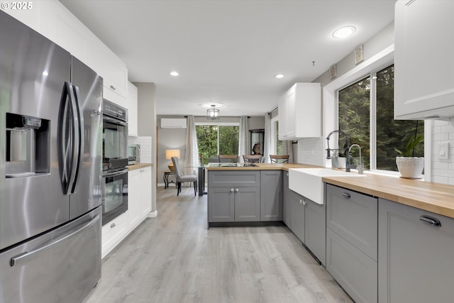 14011 NE 346th St, Battle Ground, WA 98604 - kitchen with stainless steel fridge, wooden counters, a sink, gray cabinetry, and recessed lighting