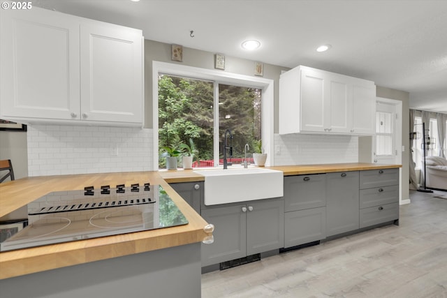 14011 NE 346th St, Battle Ground, WA 98604 - kitchen featuring butcher block counters, a sink, gray cabinetry, tasteful backsplash, and light wood-style flooring