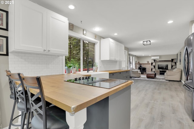 14011 NE 346th St, Battle Ground, WA 98604 - kitchen featuring wood counters, freestanding refrigerator, tasteful backsplash, open floor plan, and a sink