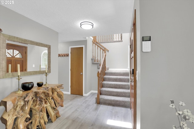 14011 NE 346th St, Battle Ground, WA 98604 - foyer entrance featuring stairs, wood finished floors, baseboards, and a textured ceiling
