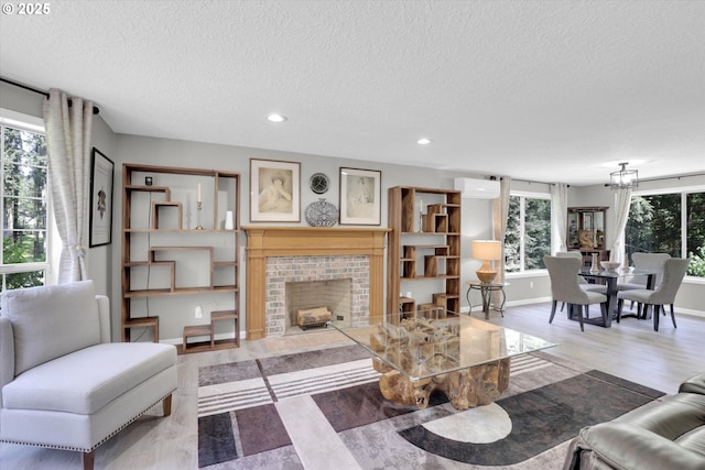 14011 NE 346th St, Battle Ground, WA 98604 - living room featuring a textured ceiling, recessed lighting, a fireplace, wood finished floors, and a chandelier