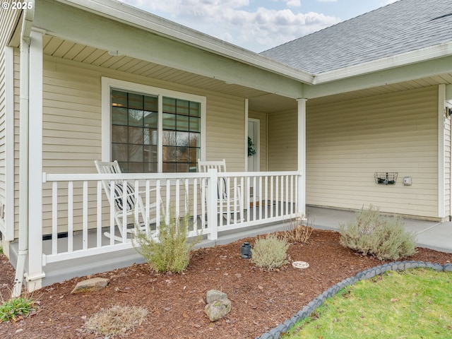 view of exterior entry featuring covered porch