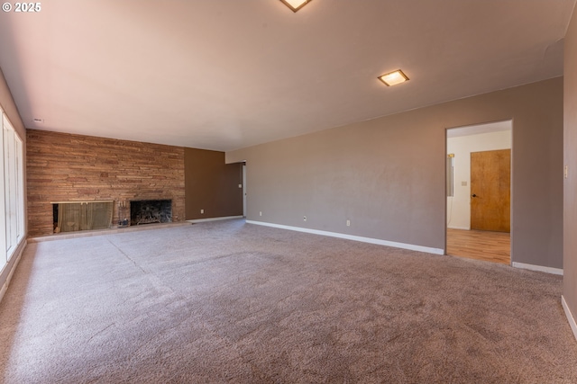 176 N Henry St, Coquille, OR 97423 - unfurnished living room with carpet flooring, a stone fireplace, and baseboards