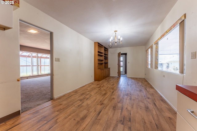 176 N Henry St, Coquille, OR 97423 - unfurnished dining area featuring a chandelier, hardwood / wood-style floors, and baseboards