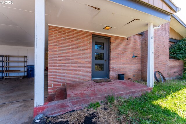 176 N Henry St, Coquille, OR 97423 - doorway to property featuring brick siding and board and batten siding