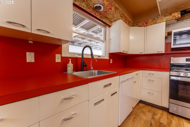 176 N Henry St, Coquille, OR 97423 - kitchen with white appliances, a sink, white cabinetry, and light wood-style floors