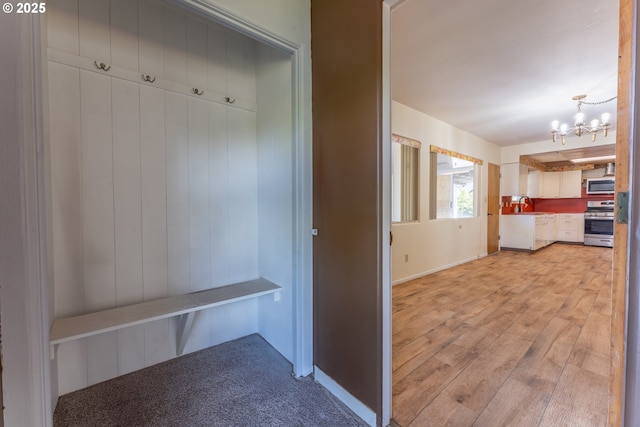176 N Henry St, Coquille, OR 97423 - mudroom featuring a chandelier, a sink, baseboards, and light wood-type flooring
