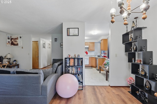 1315 SE 135th Ave, Portland, OR 97233 - living room featuring light wood-type flooring and a chandelier