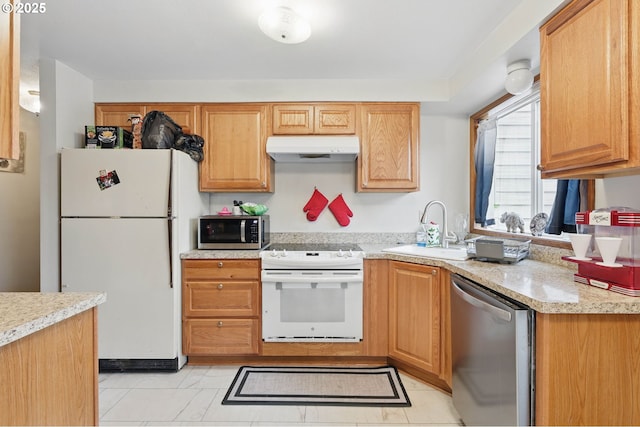 1315 SE 135th Ave, Portland, OR 97233 - kitchen with stainless steel appliances, under cabinet range hood, a sink, and light tile patterned flooring