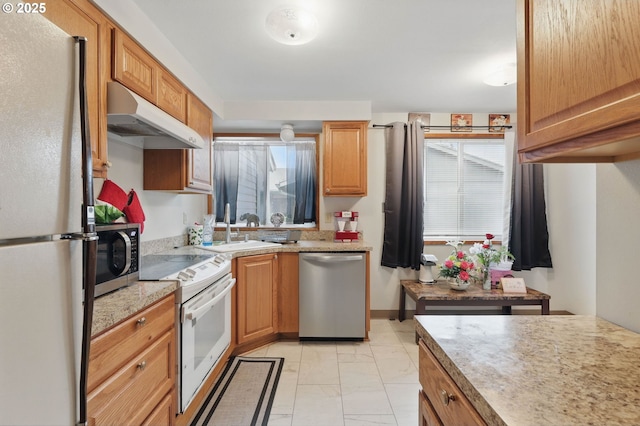 1315 SE 135th Ave, Portland, OR 97233 - kitchen with appliances with stainless steel finishes, under cabinet range hood, light marble finish floors, and a sink