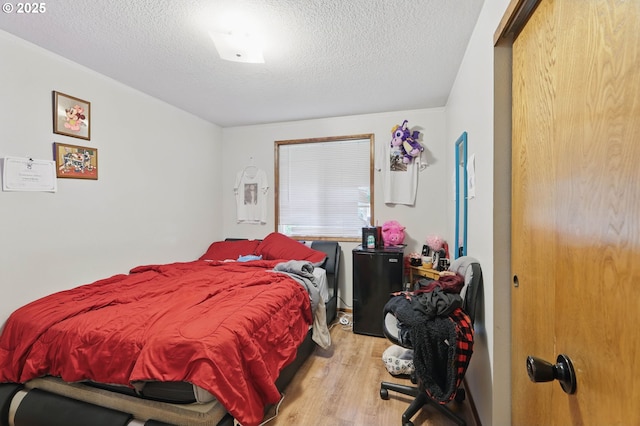 1315 SE 135th Ave, Portland, OR 97233 - bedroom featuring wood finished floors and a textured ceiling