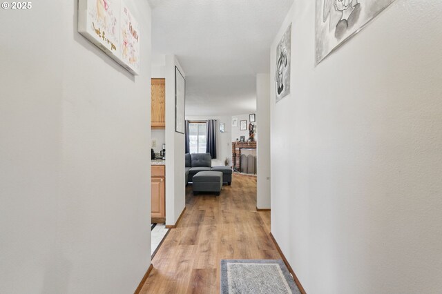 1315 SE 135th Ave, Portland, OR 97233 - hallway featuring light wood-type flooring and baseboards