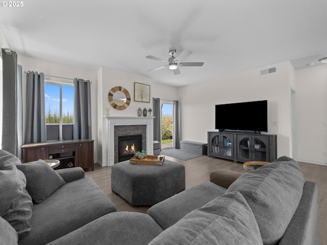 1053 Winfield St NE, Gervais, OR 97026 - living area with a ceiling fan, a glass covered fireplace, and wood finished floors