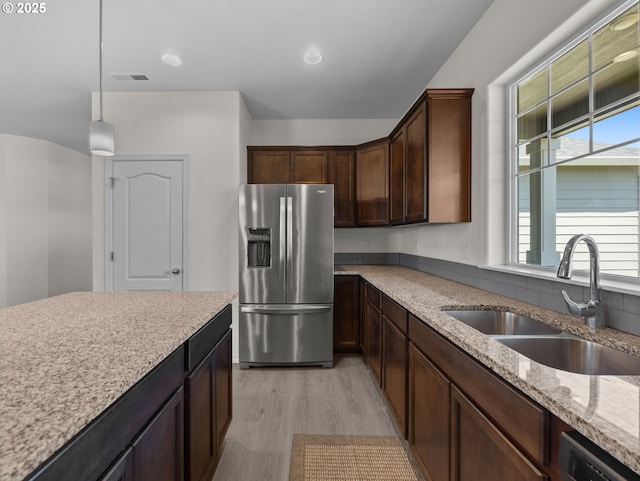 1053 Winfield St NE, Gervais, OR 97026 - kitchen with stainless steel fridge, dishwasher, light stone countertops, and plenty of natural light