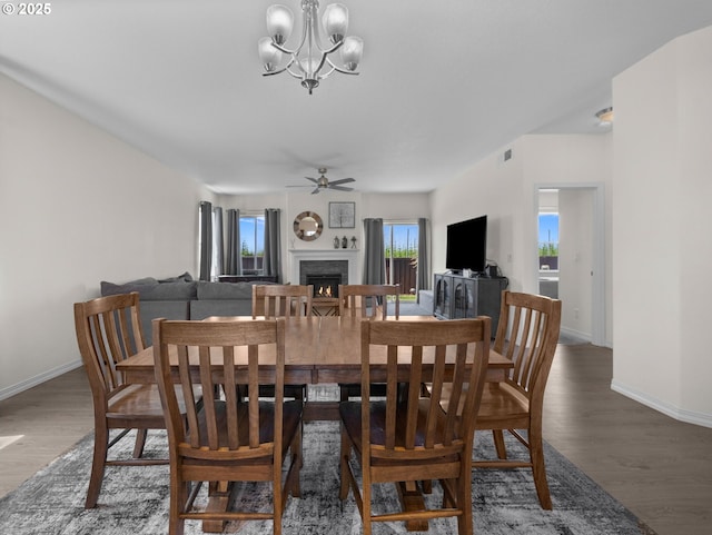 1053 Winfield St NE, Gervais, OR 97026 - dining area with a lit fireplace, ceiling fan, wood finished floors, and a chandelier