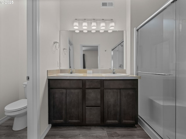 1053 Winfield St NE, Gervais, OR 97026 - full bath featuring a stall shower, double vanity, and wood finished floors