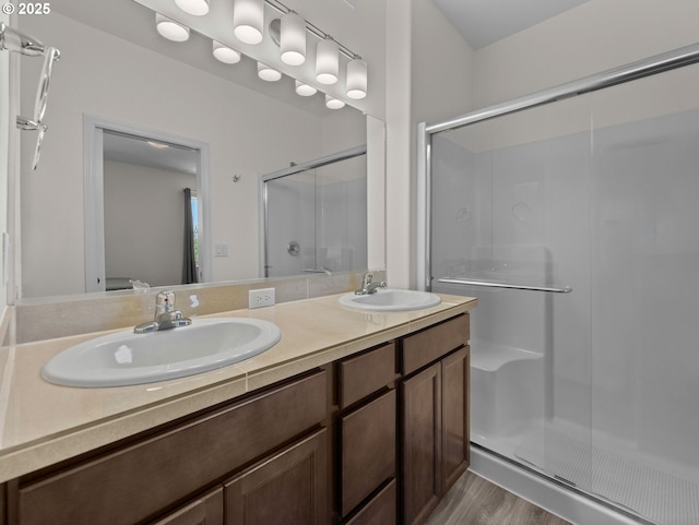 1053 Winfield St NE, Gervais, OR 97026 - full bathroom featuring a shower stall, double vanity, and wood finished floors
