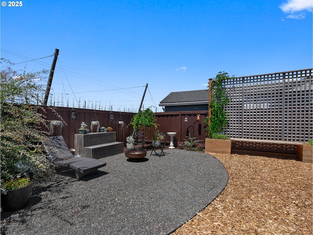 1053 Winfield St NE, Gervais, OR 97026 - fenced backyard with an outdoor fire pit and a patio area