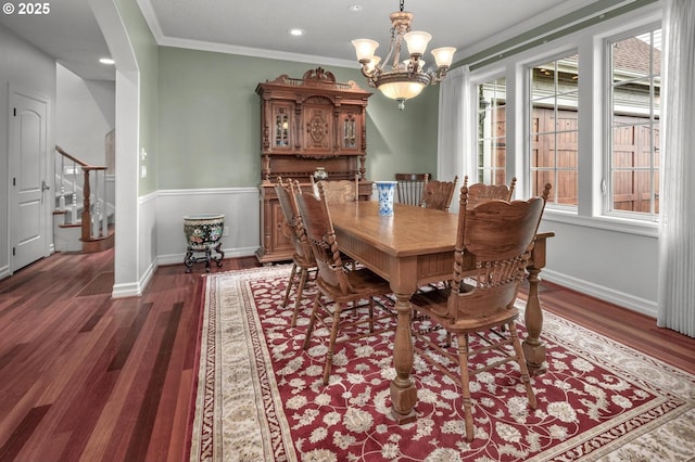 dining space with wood finished floors, a chandelier, crown molding, recessed lighting, and stairs