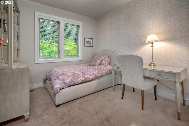 bedroom featuring carpet flooring, wallpapered walls, and baseboards