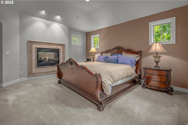 bedroom with carpet floors, baseboards, and a multi sided fireplace
