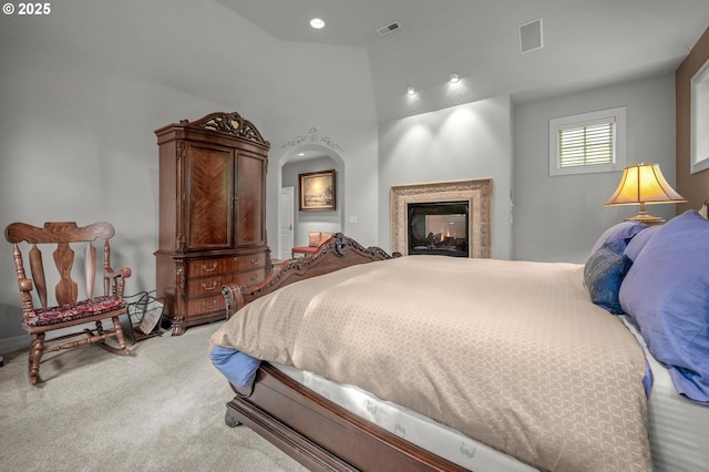 bedroom featuring carpet flooring, a multi sided fireplace, and recessed lighting
