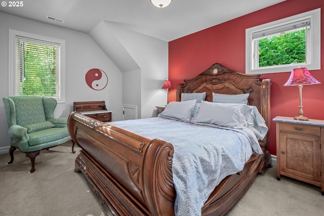 bedroom featuring light carpet and vaulted ceiling