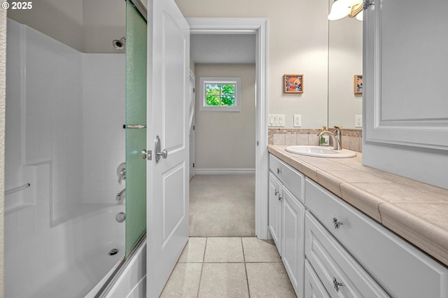 bathroom featuring shower / bath combination with glass door, vanity, tile patterned flooring, and baseboards