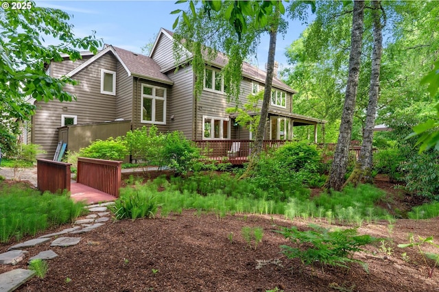 rear view of property with a wooden deck