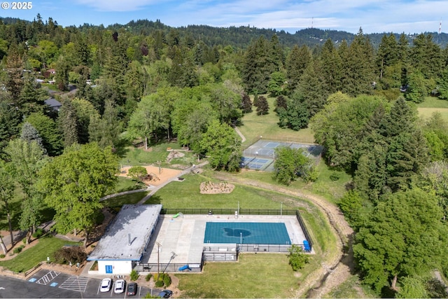 aerial overview of property's location with a heavily wooded area