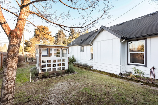 rear view of property featuring a lawn