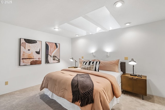 bedroom with light carpet and a skylight