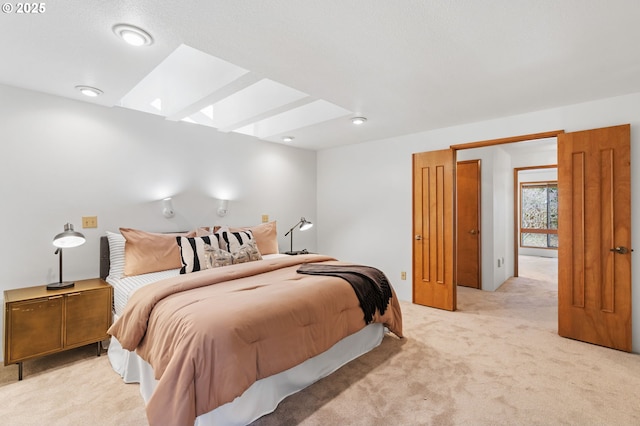 bedroom featuring light carpet and a skylight