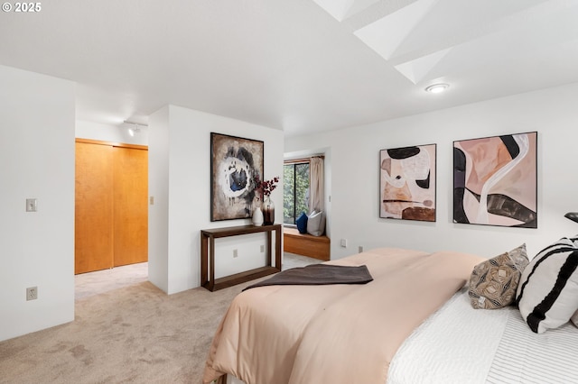 carpeted bedroom with a skylight