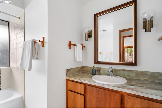 bathroom with vanity, walk in shower, and a washtub