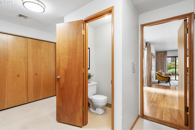 bathroom with tile patterned floors, visible vents, toilet, and baseboards