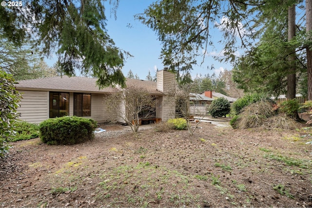 view of front of house with fence and a chimney