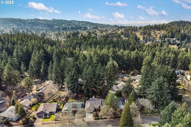 drone / aerial view featuring a residential view and a view of trees